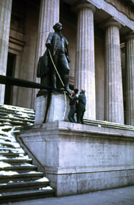 Joey Skaggs hangs a fifty foot bra on the U.S. Treasury Building on Wall Street in New York